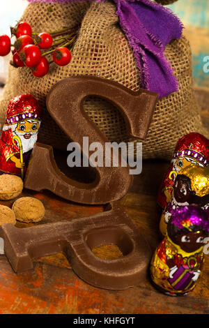 Traditional Dutch Saint Nicolas celebration with presents for children in December, Saint Nicolas  gift bag and chocolate letters close up Stock Photo