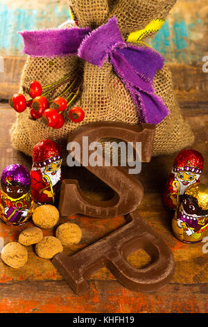 Traditional Dutch Saint Nicolas celebration with presents for children in December, Saint Nicolas  gift bag and chocolate letters close up Stock Photo