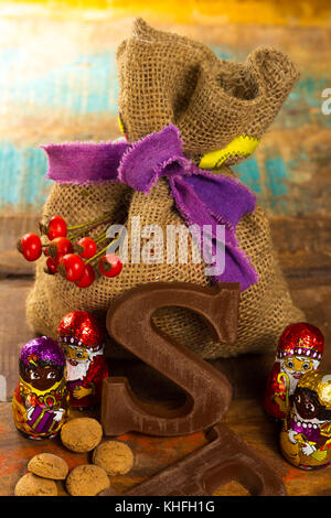 Traditional Dutch Saint Nicolas celebration with presents for children in December, Saint Nicolas  gift bag and chocolate letters close up Stock Photo