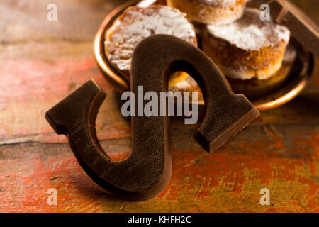 Traditional Dutch Saint Nicolas celebration with presents for children in December, Saint Nicolas  gift bag and chocolate letters close up Stock Photo