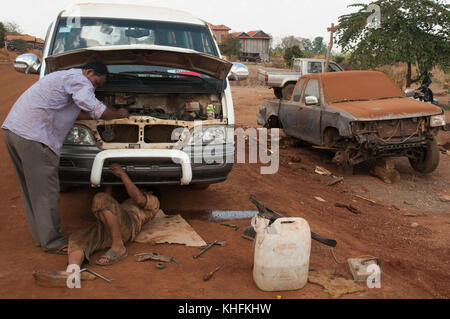 Cambodia: a makeshift roadside garage encountered in rural Mondulkiri province, where self-taught mechanics work in the dust Stock Photo