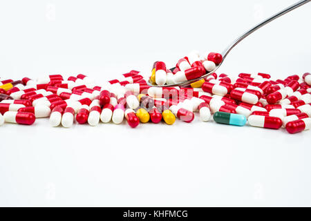 Antibiotic capsules pills in stainless steel spoon on white background with copy space. Drug resistance concept. Antibiotics drug use with reasonable  Stock Photo