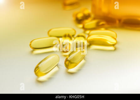 Cod liver oil omega 3 gel capsules isolated on white sunny background Stock Photo