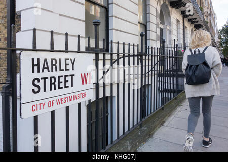 A woman walking past the famous Harley Street, City of Westminster, W1, street sign, London, England, U.K. Stock Photo