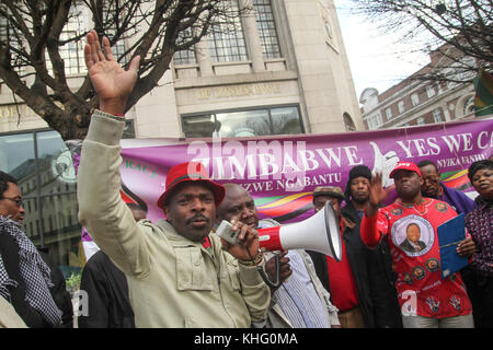 London, UK. 21 February 2015: Hundreds of Zimbabwean demonstrators take part in a demonstration outside Zimbabwe House in central London on Mugabe's 91st birthday on February 21st. Robert Gabriel Mugabe, has been President of Zimbabwe since 1987, and had previously led Zimbabwe as Prime Minister from 1980 to 1987.  Credit: David Mbiyu/Alamy Live News Stock Photo