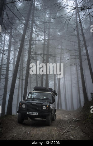 Land Rover Defender Exploring the Alps Near Sauze d'Oulx. Traveling between Str. dell' Assietta and  Sauze d'Oulx  Alpine road Negative space photo Stock Photo