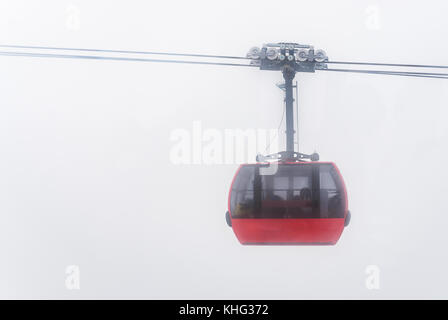 Cable car running between two snow covered mountains at a ski resort Stock Photo