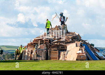 Council workers building the municipal bonfire on Plymouth Hoe ready for Guy Fawkes' night. Stock Photo