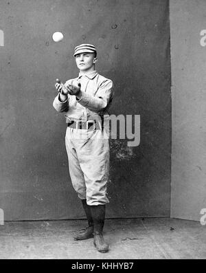 A photographic portrait of Tommy McCarthy wearing a Philadelphia Quakers uniform, in the photograph he is catching a ball that was thrown to him, he was an outfielder who played for twelve years of Major League Baseball, he was elected to the Baseball Hall of Fame in 1946, 1900. From the New York Public Library. Stock Photo