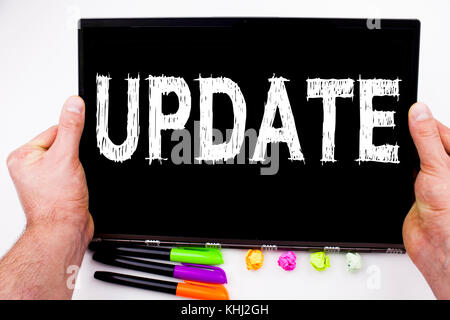 Update text written on tablet, computer in the office with marker, pen, stationery. Business concept for Digital Internet Improvement white background Stock Photo