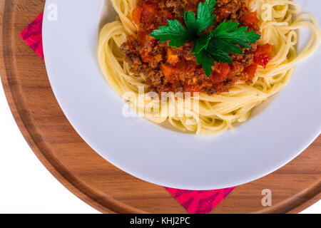 Top view of plate of spaghetti pasta with tomato bolognese sauce, isolated on white background. Stock Photo