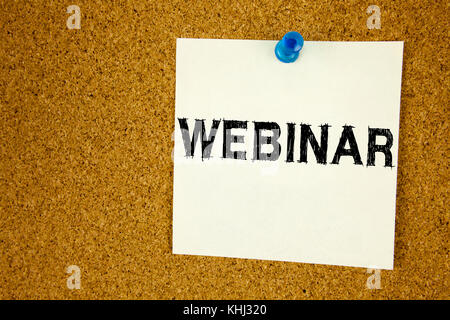 Hand writing text caption inspiration showing Webinar concept meaning Online Training Development Business Workshop written on sticky note, reminder i Stock Photo