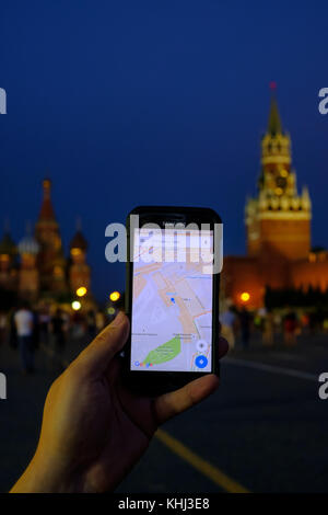 Male hand holding a smartphone with  running Google maps app Stock Photo