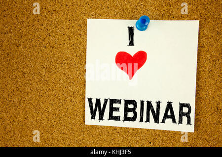 Hand writing text caption inspiration showing Webinar concept meaning Love Online Training Development Business Workshop written on sticky note, remin Stock Photo