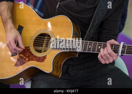 Man plays acoustic guitar Stock Photo