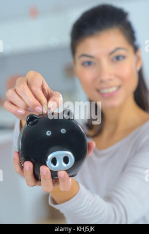 Beautiful mature woman with piggy bank on white background Stock Photo ...