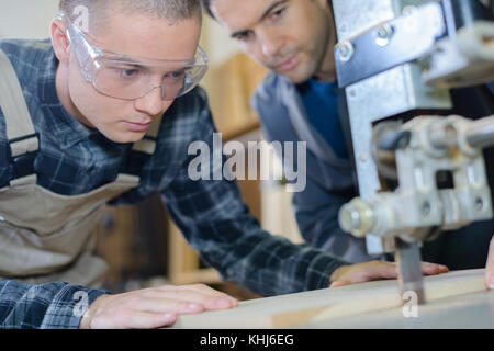male engineer in factory using milling machine Stock Photo