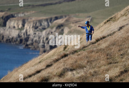 Search and rescue teams perform a search on the cliffs above the coast near to Swanage in Dorset as police officers continue their investigation into the disappearance of Gaia Pope. Stock Photo