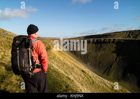 Hiker Viewing High Cup Nick from the Pennine Way, Cumbria, UK Stock Photo