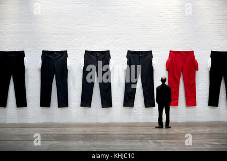 A series of XXXXXXL pairs of trousers with their pockets flung out at the Tramway Arts Centre in Glasgow, which is part of an exhibit by Los Angeles-based artist Amanda Ross-Ho, and forms part of an installation meant to represent a factory floor. Stock Photo
