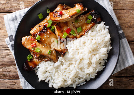 grilled king oyster mushrooms with rice and teriyaki sauce close-up on a plate. horizontal top view from above Stock Photo