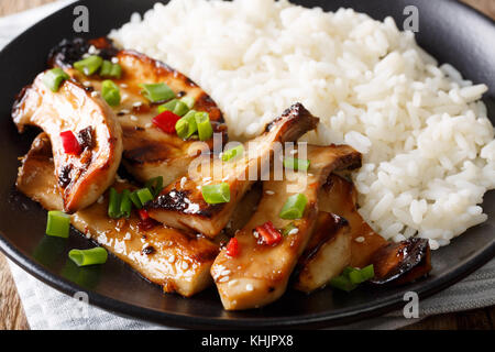 grilled king oyster mushrooms with rice and teriyaki sauce close-up on a plate. horizontal Stock Photo