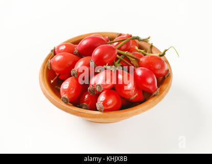 bowl of ripe rose hips on white background Stock Photo