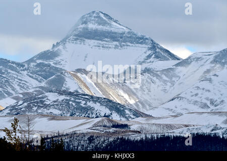 A winter image of a snow covered mountain on a dull overcast day in the Alberta Foothills near Cadomin Alberta Canada. Stock Photo