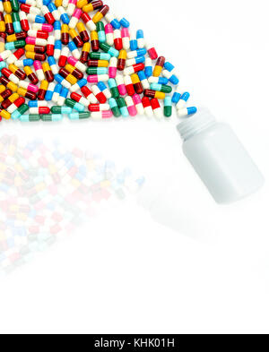 Antibiotic capsules spilling out of pill bottle on white background with copy space and shadows. Drug resistance concept. Antibiotics drug use with re Stock Photo