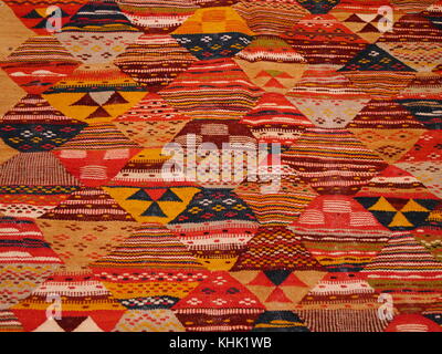 Close up of part of traditional handmade Moroccan carpet with intricate bright geometric pattern Stock Photo