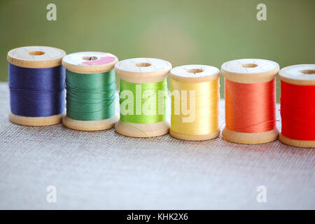 Wooden Spools of Thread in Various Colors Stock Photo