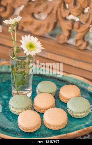 Pink and pale green macaroons in a green ceramic plate Stock Photo