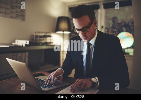 Serious business man working on documents looking concentrated Stock Photo