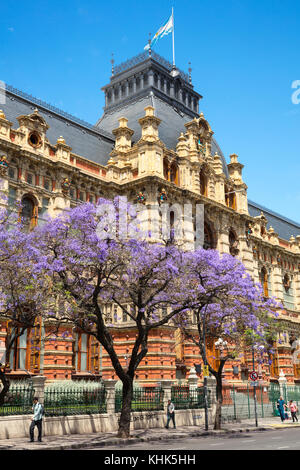 The 'Palacio de Aguas Corrientes' (Water Company Palace) with Jacaranda trees in springtime. Buenos Aires, Argentina. Stock Photo