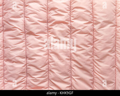 Pale pink striped quilted winter cloth background Stock Photo