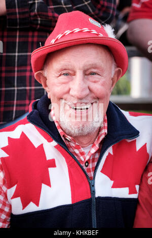 Portrait of male Canadian senior citizen celebrating Canada Day wearing a hat, red and white national colours, smiling at camera. Stock Photo