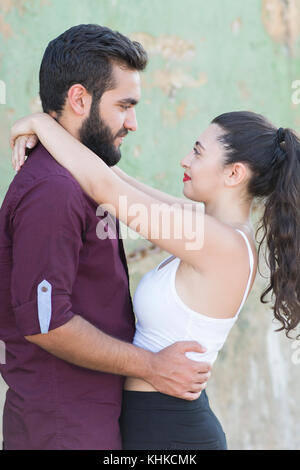 Young Middle Eastern couple hugging outdoors Stock Photo