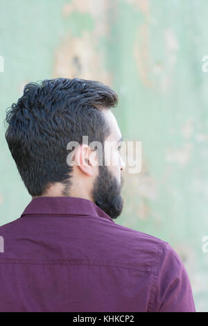 Rear view of a bearded Middle Eastern man looking away outdoors Stock Photo