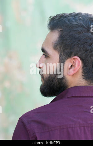 Rear view of a bearded Middle Eastern man looking away outdoors Stock Photo