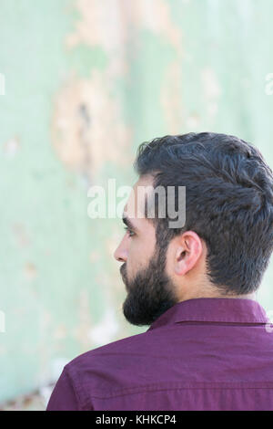 Rear view of a bearded Middle Eastern man looking away outdoors Stock Photo