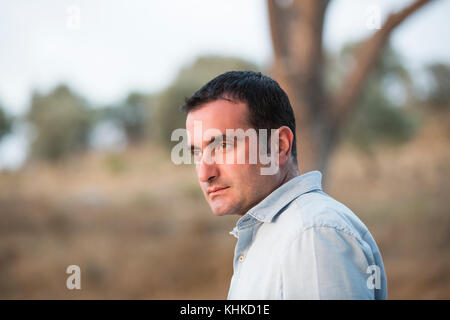Middle Eastern man looking away outdoors Stock Photo