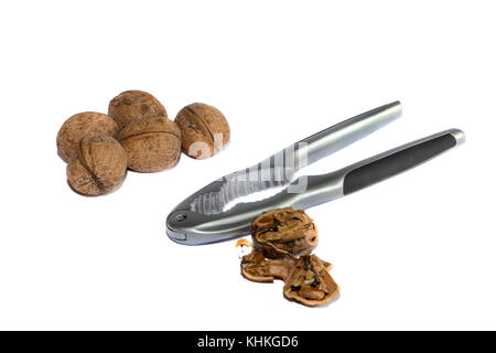 Group of walnuts and broken walnuts with a Nutcracker, isolated  on white background Stock Photo