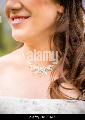 Womanly brunette bride in white dress with bridal veiling and