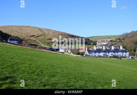 The village at Lulworth Cove showing the footpath leading to Durdle Door, Dorset, UK - John Gollop Stock Photo