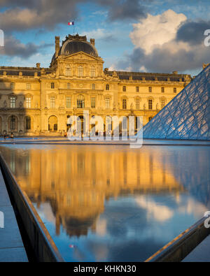 Colorful clouds at sunset over the courtyard of Musee du Louvre, Paris, France Stock Photo