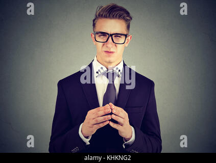 Sly business man in glasses looking at camera Stock Photo