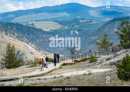 YELLOWSTONE NATIONAL PARK, WYOMING, USA - JULY 17, 2017: Tourists on boardwalk at Mammoth Hot Springs Terraces. Yellowstone Park, USA Stock Photo