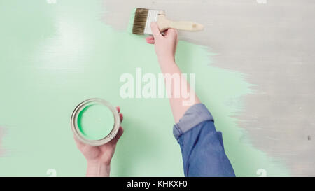 Home inprovement project. Painting wood with turquose color paint. Stock Photo