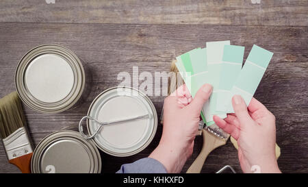 Home inprovement project. Painting wood with turquose color paint. Stock Photo