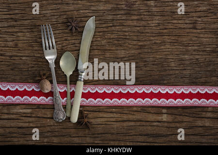 Cutlery with star anise and nutmeg on wooden table Stock Photo
